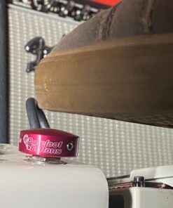 A shoe pressing a Barefoot Buttons V1 Standard Red footswitch topper installed on a guitar pedal.