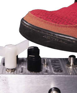 A red shoe is on top of an electronic device.