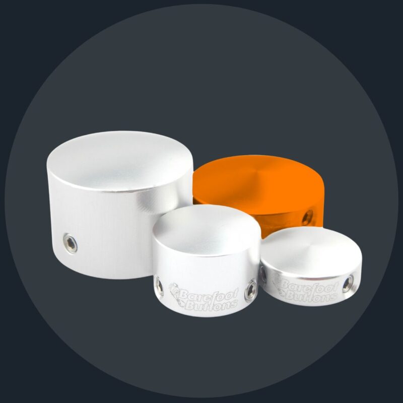 A group of four white containers with orange lids.