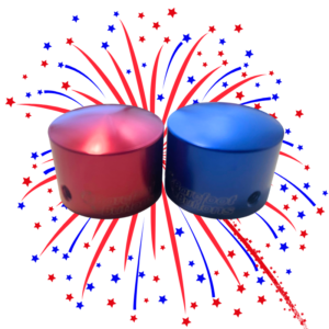 An image of a red and blue V1 tallboy Barefoot Button with a firework in the background