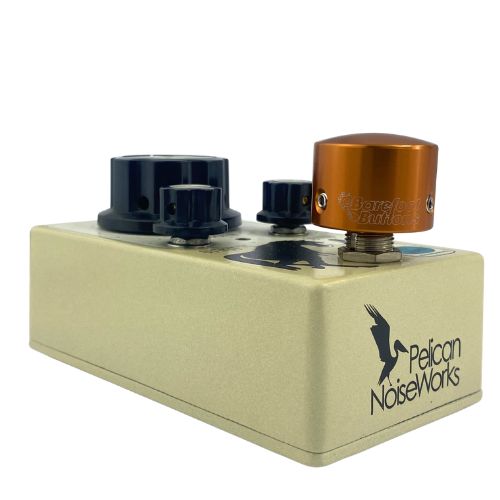 Barefoot Buttons V1 Tallboy Orange footswitch topper installed on an angled guitar effects pedal switch